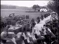 Ces images montrent les forces allemandes entrant dans les Sudètes. Aux termes des accords de Munich, l'Allemagne annexa cette région majoritairement germanophone de la Tchécoslovaquie. Les accords de Munich furent signés par l'Allemagne, l'Italie, la Grande-Bretagne et la France, et la Tchécoslovaquie ne fut pas autorisée à participer à la conférence. Plus tard, Hitler devait violer les accords en détruisant l'Etat tchèque en 1939.