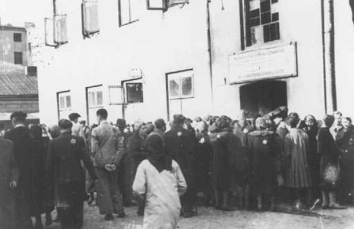 Jews in the Lodz ghetto line up outside the labor office of the Jewish council in the hopes of finding employment outside the ghetto. [LCID: 80561]