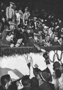 Adolf Hitler and Joseph Goebbels sign autographs for members of the Canadian figure skating team at the Winter Olympic Games.