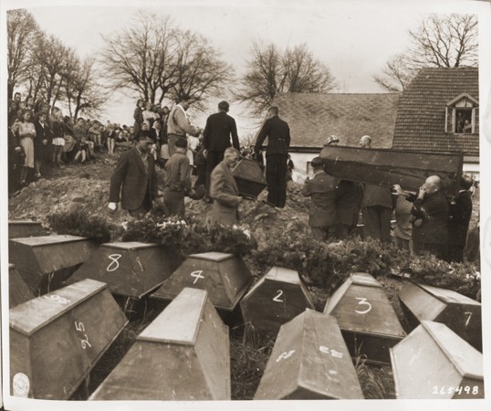 <p>German civilians from Volary attend burial services for the Jewish women exhumed from a mass grave in the town. The victims died at the end of a <a href="/narrative/2931">death march</a> from Helmbrechts, a subcamp of <a href="/narrative/6783">Flossenbürg</a>. Germans were forced to exhume them in order to give the victims proper burial. Volary, Czechoslovakia, May 11, 1945.</p>