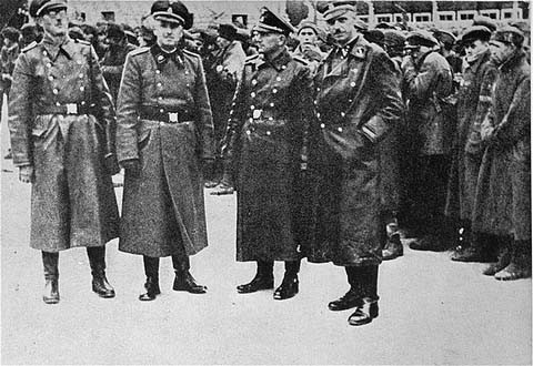 SS officers posing in front of a newly arrived transport of Soviet prisoners of war.