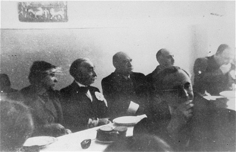 A meeting of the Warsaw Jewish council. Sitting behind table, 2nd to 4th from left: industrialist Abraham Gepner; chairman Adam Czerniakow; and lawyer Gustav Wielikowski.