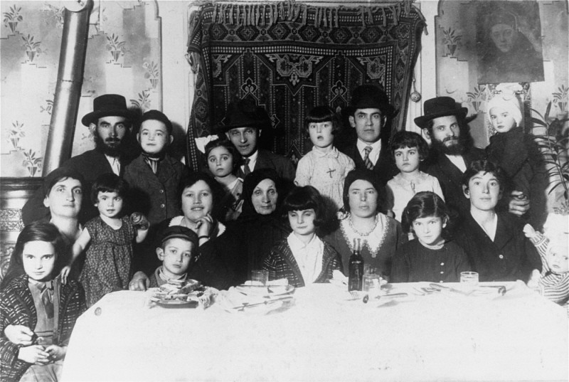 Portrait of the Ehrlich family seated around the family table. Munkacs, Czechoslovakia, 1930.
Among those pictured is Elizabeth Ehrlich (later Roth) standing in the middle of the back row in a light dress, and Rella Ehrlich (front row, second from the right). Elizabeth was born in Munkacs. In 1944 she was confined to the ghetto there before being deported with her family to Auschwitz. She was later transferred to a camp in Bydogszcz, Poland, and from there to the Stutthof concentration camp.