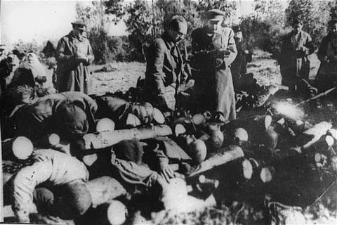 Soviet officials view stacked corpses of victims at the Klooga camp. [LCID: 03182]