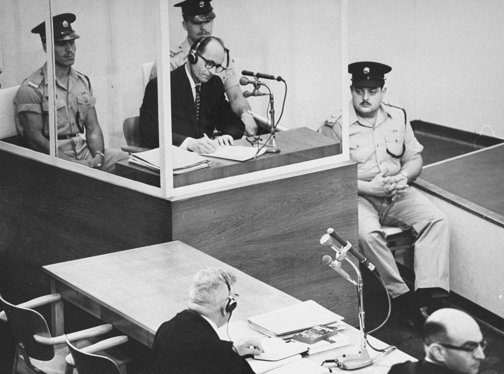 Defendant Adolf Eichmann takes notes during his trial in Jerusalem in 1961.