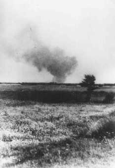 Distant view of smoke from the Treblinka killing center, set on fire by prisoners during a revolt. This scene was photographed by a railway worker. Treblinka, Poland, August 2, 1943.