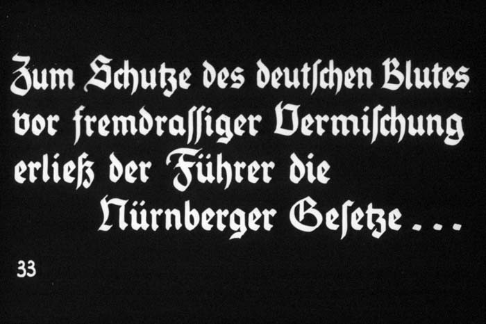 33rd Nazi propaganda slide of a Hitler Youth educational presentation entitled "Germany Overcomes Jewry."