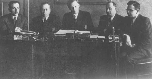 A meeting of the Kovno ghetto Jewish council. Chairman Elchanan Elkes sits at the center.