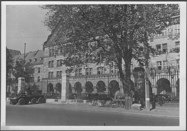 An armored car parked outside the gate of the Palace of Justice in Nuremberg on the day the judgement of the International Military ... [LCID: 94550]