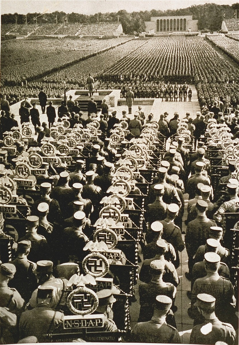 Rows of SA standard bearers line the field behind the speaker's podium at the 1935 Nazi Party Congress. [LCID: 07473]