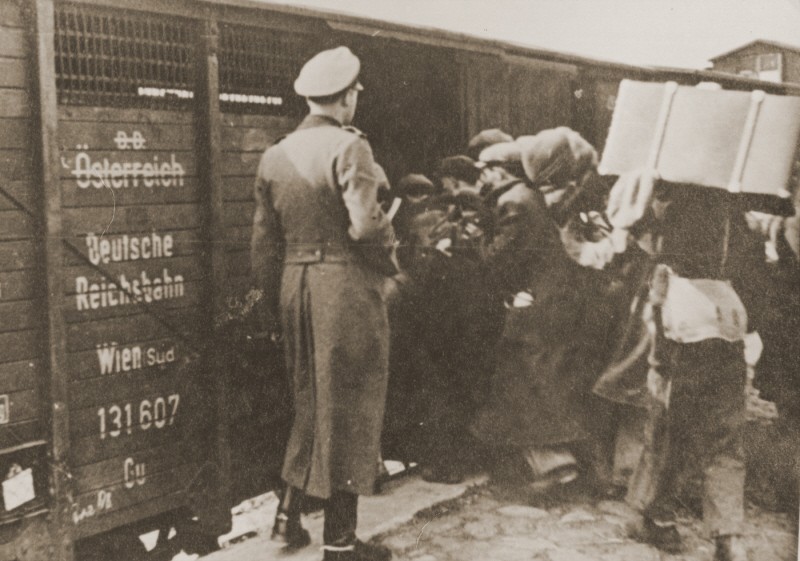 Jews are forced into boxcars for deportation to the Belzec killing center. Lublin, Poland, 1942.