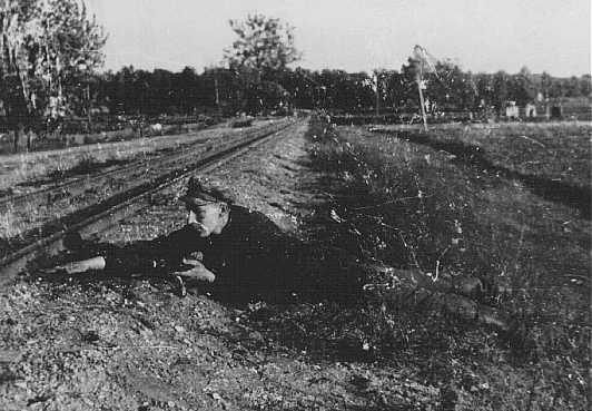 Jewish partisan Boris Yochai plants dynamite on a railroad track.