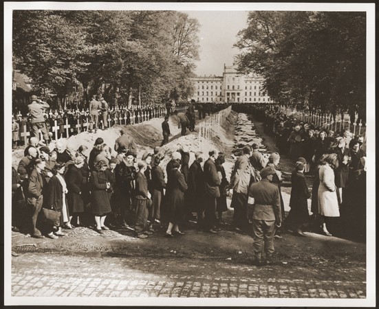 German civilians from Ludwigslust file past the corpses and graves of 200 prisoners from the nearby concentration camp of Wöbbelin. [LCID: 19144]