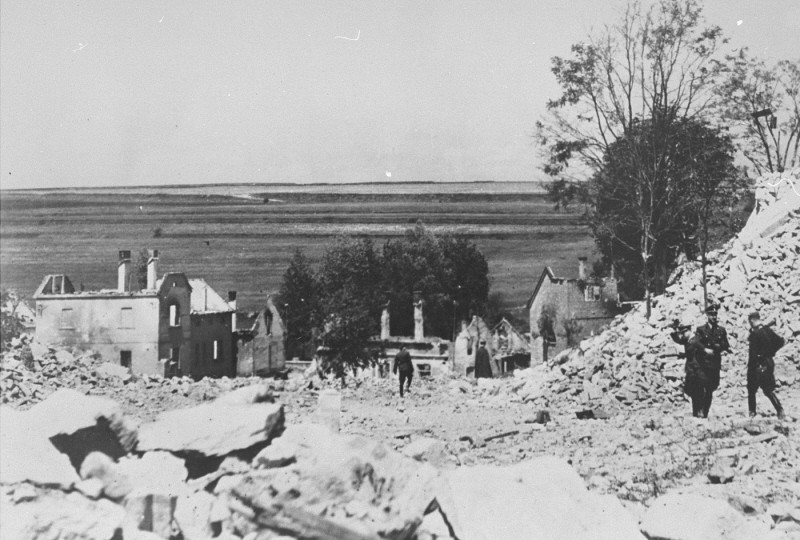 SS officers stand among the rubble of Lidice during the demolition of the town's ruins in reprisal for the assasination of Reinhard ... [LCID: 70929]