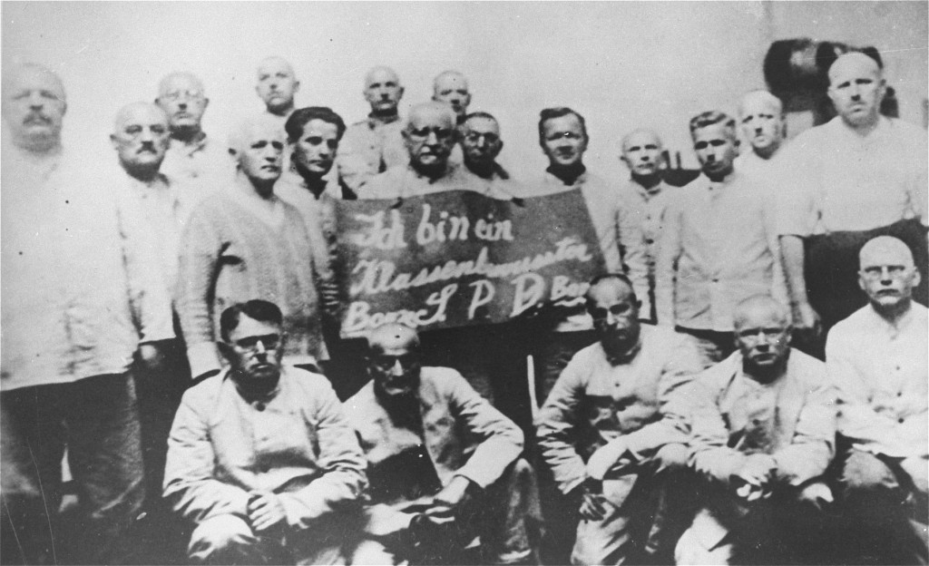 Humiliation of prisoners: Social Democratic Party (SPD) inmates hold a placard which reads "I am a class-conscious person, party ... [LCID: 48066b]