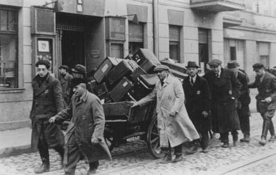 Jews deported from Prague, Czechoslovakia, move their belongings through the streets. [LCID: 29082b]