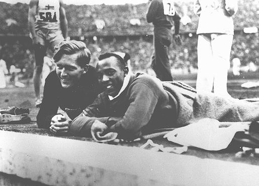 Athletes Jesse Owens of the United States (right) and Lutz Long of Germany at the Olympic stadium. [LCID: 43338]