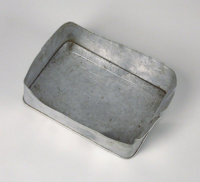 Aluminum food container lid used by a Hungarian Jewish family on the Kasztner train. [LCID: n09725]