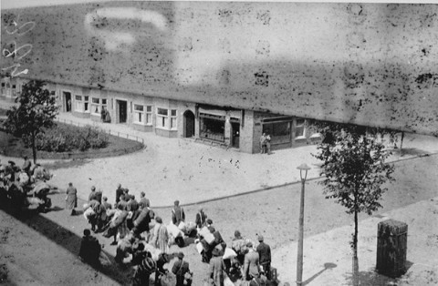 Jews carry luggage to an assembly point before deportation to the Westerbork camp.
