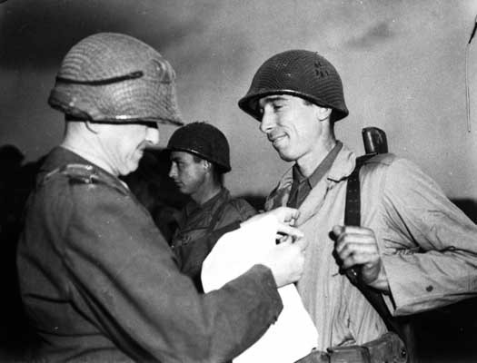 Sergeant Alexander Drabik, the first American soldier to cross the bridge at Remagen, receiving the Distinguished Service Cross for ... [LCID: sc249]