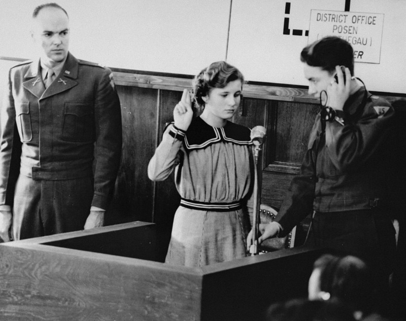 Fifteen-year-old Maria Dolezalova is sworn in as a prosecution witness at the RuSHA Trial. [LCID: 07341]