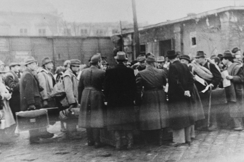 At the Jozsefvarosi train station in Budapest, Raoul Wallenberg (at right, with hands clasped behind his back) rescues Hungarian Jews from deportation by providing them with protective passes.