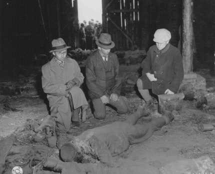 Three German mayors view the corpse of a prisoner burned alive in a barn by the SS while on a death march from Rottleberode, a subcamp ... [LCID: 45438]
