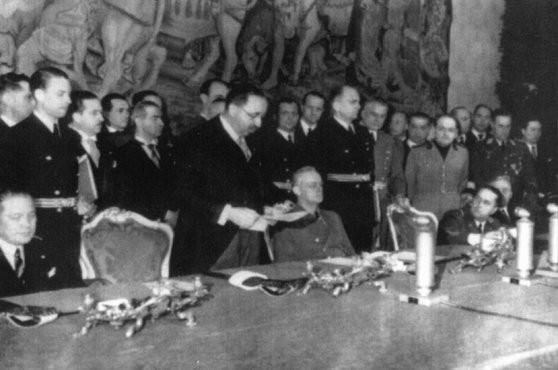 Bulgarian leader Bogdan Filov (standing) and German foreign minister Joachim von Ribbentrop (seated, center) during the signing of ... [LCID: tl118]