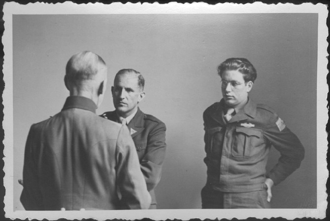 German Field Marshal Gerd von Rundstedt (with his back to the camera) speaks to American prosecutor Robert Kempner (left) and interpreter Gerald Schwab during a pause at the IMT Nuremberg commission hearings investigating the Supreme Command of the German Armed Forces.