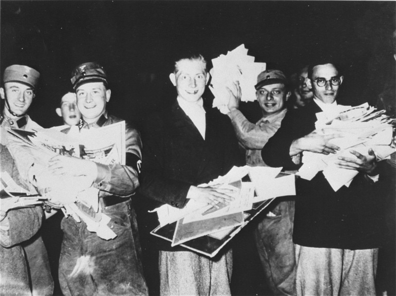 Students and members of the SA with armfuls of literature deemed "un-German" during the book burning in Berlin. [LCID: 69031]