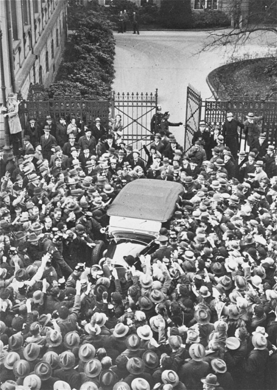 A crowd cheers Adolf Hitler as his car leaves the Reich Chancellery following a meeting with President Paul von Hindenburg.