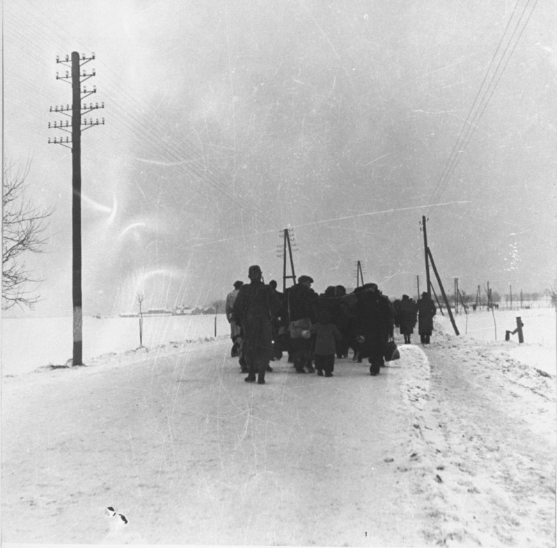 A transport of Jewish prisoners marches through the snow from the Bauschovitz train station to Theresienstadt. [LCID: 69720]
