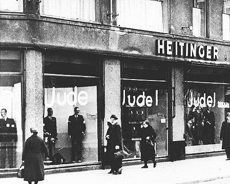 Windows of a Jewish-owned store painted with the word "Jude" (Jew).