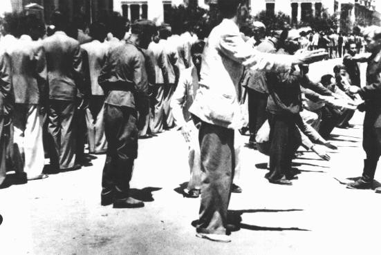 Public humiliation of Jews in Liberty Square during compulsory registration for forced labor.