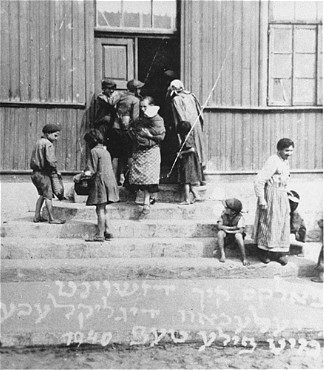 Women and children at the door of a soup kitchen maintained by the American Jewish Joint Distribution Committee. [LCID: 49020]