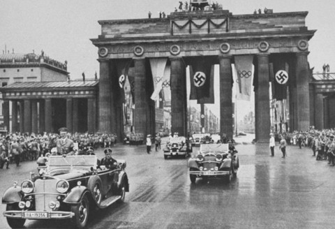 Adolf Hitler passes through the Brandenburg Gate on the way to the opening ceremonies of the Olympic Games.