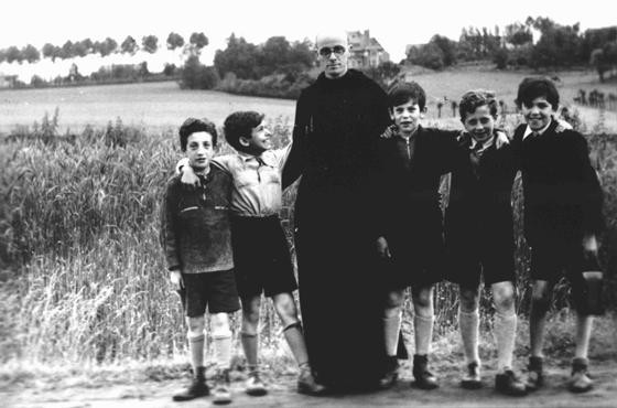 Father Bruno with Jewish children he hid from the Germans. [LCID: 08732]