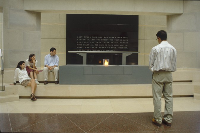 Visitors view the eternal flame in the Hall of Remembrance at the United States Holocaust Memorial Museum. [LCID: n0177501]