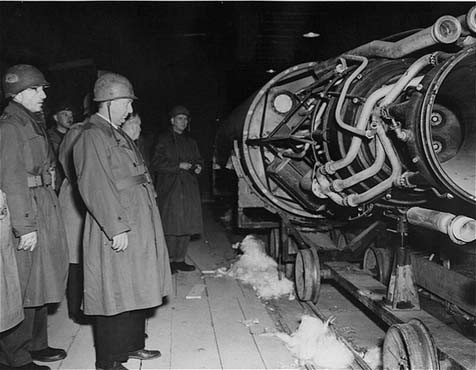Members of a US congressional committee investigating German atrocities view a V-2 rocket on the assembly line of an underground ... [LCID: 91683]