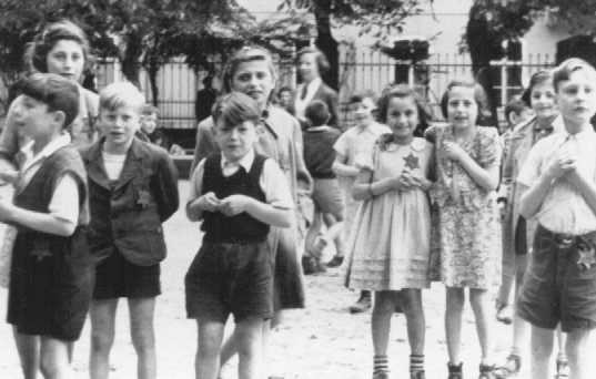 A photograph of Jewish children in the Theresienstadt ghetto taken during an inspection by the International Red Cross. Prior to this visit, the ghetto was "beautified" in order to deceive the visitors. Czechoslovakia, June 23, 1944.