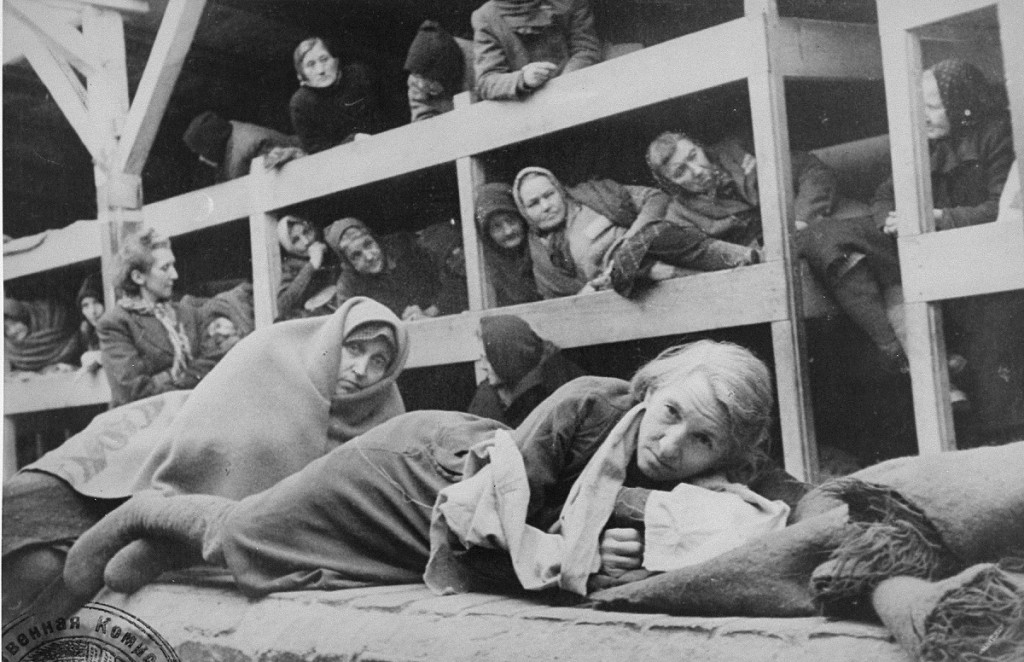 Women survivors huddled in a prisoner barracks shortly after Soviet forces liberated the Auschwitz camp.