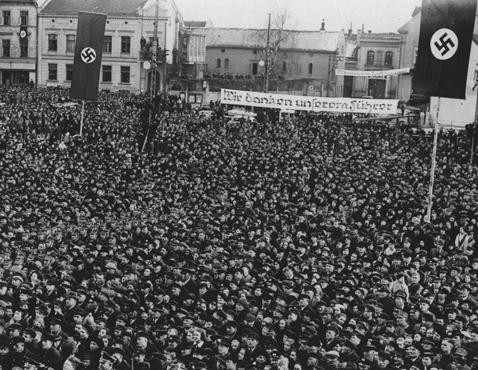 Following Germany's annexation of Memel from Lithuania, a crowd of Germans in Memel's marketplace listens to Hitler speak. [LCID: 20350]