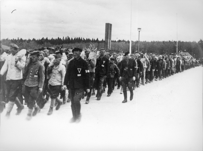 Returning from work in a stone quarry, forced laborers carry stones more than six miles to the Buchenwald concentration camp. [LCID: 19087]