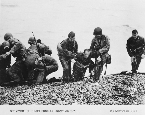 American troops pull the survivors of a sunken craft on to the shores of the Normandy beaches on D-Day. [LCID: 65996]