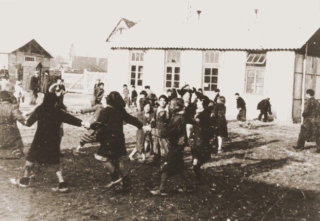 Romani (Gypsy) children play outside at the Jargeau internment camp. [LCID: 97422]