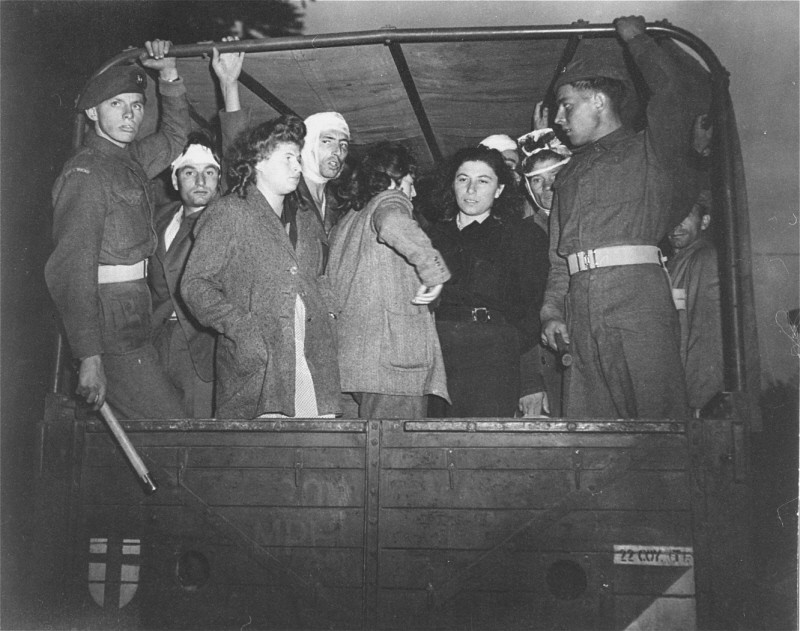 British soldiers guard Jewish refugees, forcibly removed from the ship "Exodus 1947," on trucks leaving for Poppendorf displaced persons camp.