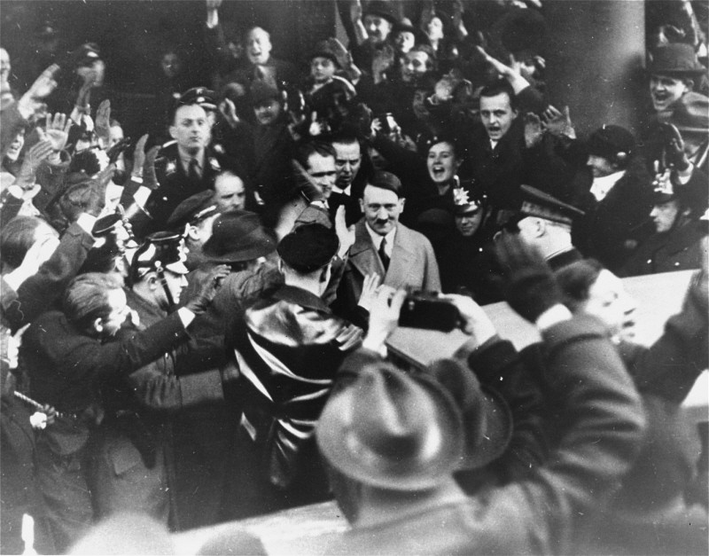 Germans cheer Adolf Hitler as he leaves the Hotel Kaiserhof just after being sworn in as chancellor. [LCID: 69710]