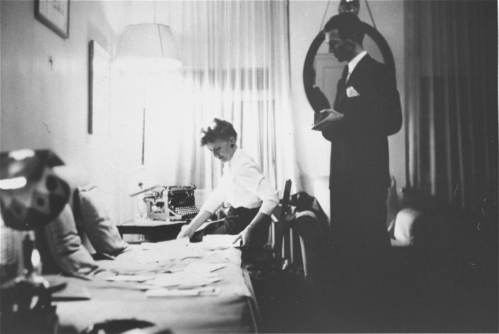 Jan Karski (standing), underground courier for the Polish government-in-exile. He informed the west in the fall of 1942 about Nazi atrocities against Jews taking place in Poland. Pictured in his office in Washington, DC, United States, 1944.