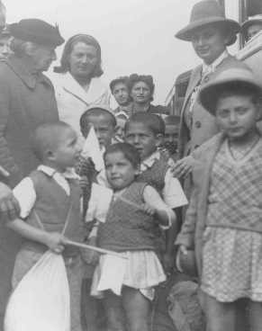 Henrietta Szold (left, in hat), founder of the Hadassah Women's Zionist Organization, welcomes some of the Polish Jewish refugee children known as the "Tehran Children," upon their arrival in Palestine.