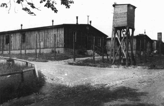 A watchtower and barracks at the Ohrdruf subcamp of the Buchenwald concentration camp. [LCID: 15095]